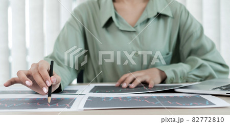 Hand of businesswoman are planning business investments related to shares By analyzing and calculating the stock market for marketing profits Hand of businesswoman are planning business investments related to shares By analyzing and calculating the stock market for marketing profits 82772810