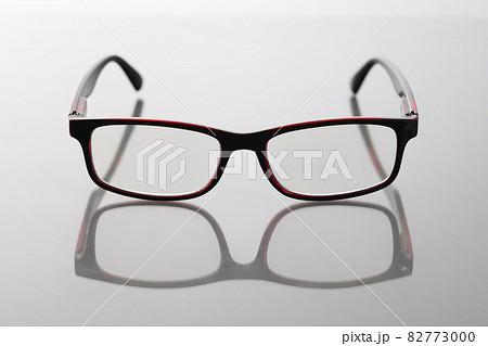 Modern stylish glasses with dark frames on table 82773000