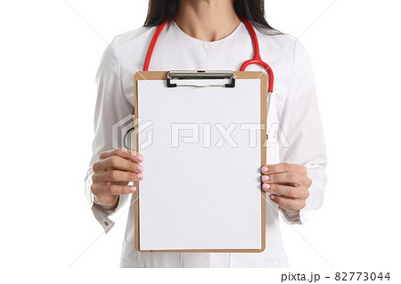 Doctor holding white blank clipboard on white background 82773044