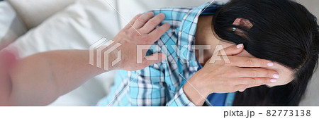 Man hit woman on couch in face closeup Man hit woman on couch in face closeup 82773138