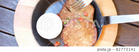 Taste cooked pancakes in pan with sour cream closeup Taste cooked pancakes in pan with sour cream closeup 82773141