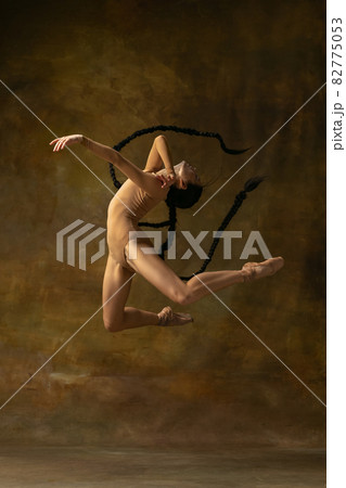 Full-length art portrait of beautiful ballerina dancing isolated over vintage background. Freedom expression. Renaissance performance Full-length art portrait of beautiful ballerina dancing isolated over vintage background. Freedom expression. Renaissance performance 82775053