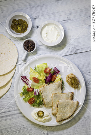 chicken quesadilla with rice, beans, salad, chalapenos and salsa 82776037