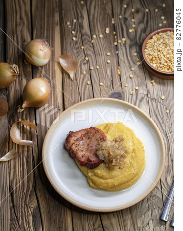 Czech cuisine, smoked meat with pea porridge and fried onion until golden Czech cuisine, smoked meat with pea porridge and fried onion until golden 82776045