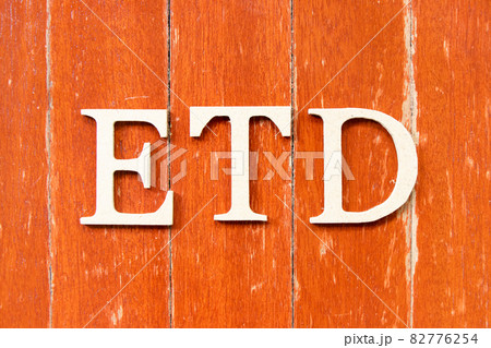 Alphabet letter in word ETD (abbreviation of estimated time of departure or the estimated time of delivery) on old red color wood plate background 82776254