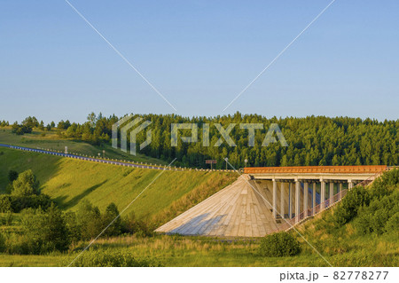 Unique concrete bridge and road against background of forest. 82778277