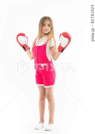 Happy kid in boxing gloves isolated on white. Little girl Happy kid in boxing gloves isolated on white. Little girl 82781024