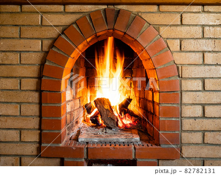 front view of brick fireplace with burning woods 82782131