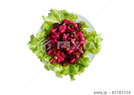 Vinaigrette isolated on a white background. Traditional Russian vegetable salad with red beets on a plate. 82782258