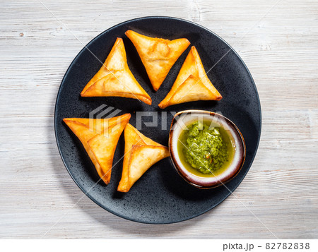 portion of Peruvian Empanadas on plate on board 82782838