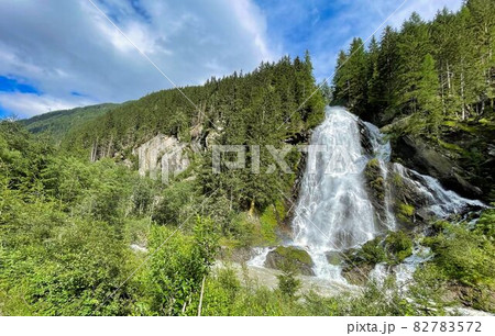 wooden walkpath as bridge over cascading waterfall 82783572