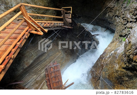 wooden walkpath as bridge over cascading waterfall wooden walkpath as bridge over cascading waterfall 82783616