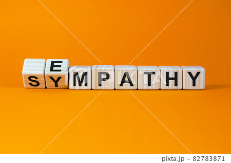 Erom sympathy to empathy. Turned cubes and changed the word 'sympathy' to 'empathy'. Beautiful orange background. Copy space. Psychological, sympathy and empathy concept. 82783871