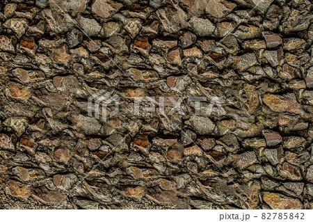 stone wall old and weathered from brown cobblestones 82785842