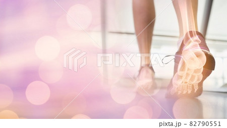 Composition of spots of light over woman running on treadmill with foot bones showing 82790551