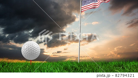 Composition of golf ball in grass on red tee, american flag and copy space Composition of golf ball in grass on red tee, american flag and copy space 82794321
