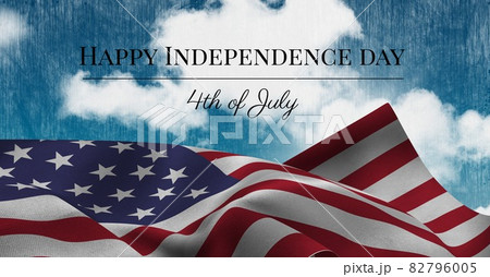 Happy independence day text and waving american flag against clouds in blue sky 82796005