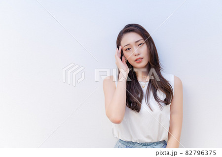 頭を押さえて辛そうな表情をする女性 82796375