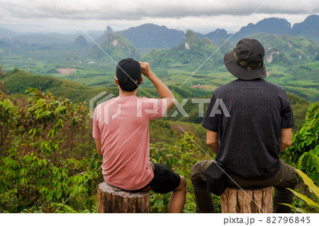 2 men relax after hiking to top of mountain in raining season travel 2 men relax after hiking to top of mountain in raining season travel 82796845