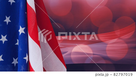 Composition of billowing american flag over defocussed red bokeh lights on dark background Composition of billowing american flag over defocussed red bokeh lights on dark background 82797019