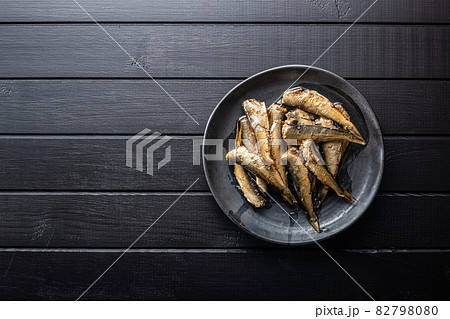 Smoked sprats on plate. Canned sea fish Smoked sprats on plate. Canned sea fish 82798080