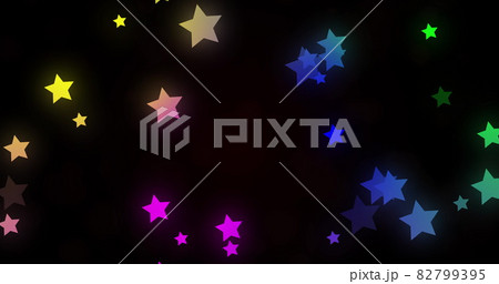 Image of glowing multi coloured stars moving in hypnotic motion on black background 82799395