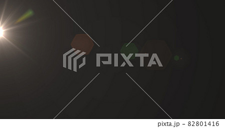 Glowing yellow spot of light flickering against black background Glowing yellow spot of light flickering against black background 82801416