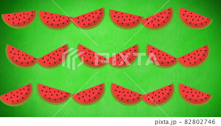 Composition of rows of watermelon slices on green background Composition of rows of watermelon slices on green background 82802746