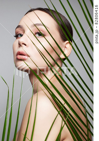 beautiful girl in palm leaves. Beauty Portrait beautiful girl in palm leaves. Beauty Portrait 82806416