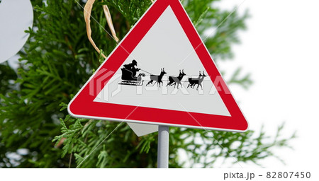Digital image of santa claus in sleigh being pulled by reindeers on signboard 82807450