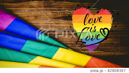 Love is love text and rainbow flag over wooden boards 82808367