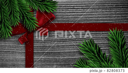 Image of christmas red present ribbon with snow falling on grey Image of christmas red present ribbon with snow falling on grey 82808373