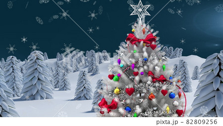 Image of winter scenery with christmas tree and snow falling on blue background 82809256