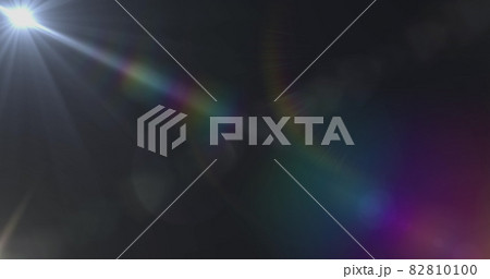 Spot of light and lens flare against black background Spot of light and lens flare against black background 82810100