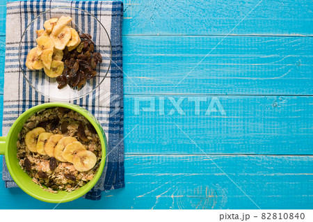 Porridge, oats, milk and banana on the table Porridge, oats, milk and banana on the table 82810840