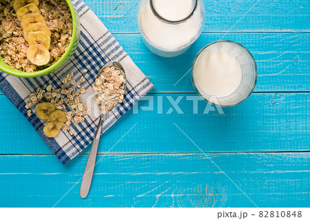 Porridge, oats, milk and banana on the table Porridge, oats, milk and banana on the table 82810848