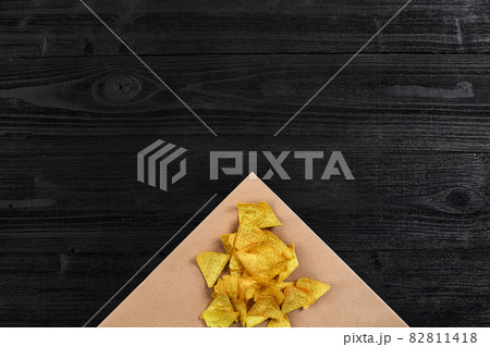 Tortilla chips on black wooden table. Top view Tortilla chips on black wooden table. Top view 82811418