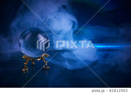 Crystal ball in a dark blue smoky background. Guessing for the future. Crystal ball in a dark blue smoky background. Guessing for the future. 82812003