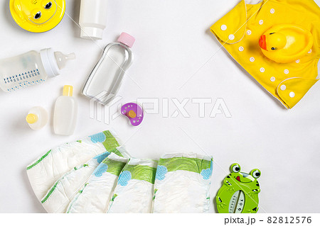 Babies goods diaper, baby powder, cream, shampoo, oil on white background with copy space. Top view or flat lay. Babies goods diaper, baby powder, cream, shampoo, oil on white background with copy space. Top view or flat lay. 82812576