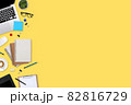 flat lay workspace table with laptop computer, office supplies, coffee cup, tablet and cell phone on yellow pastel background 82816729