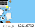 flat lay workspace table with laptop computer, office supplies, coffee cup, tablet and cell phone on blue pastel background 82816732