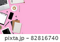 flat lay workspace table with laptop computer, office supplies, coffee cup, tablet and cell phone on pink pastel background 82816740