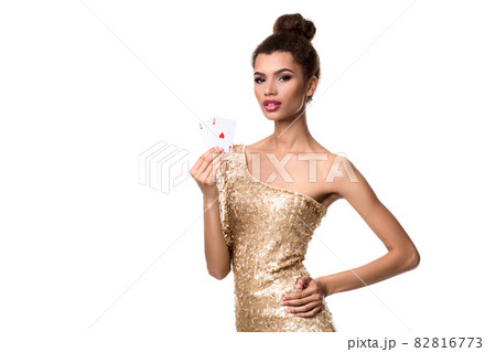 Beautiful young woman holding two ace of cards in her hand isolated on white 82816773