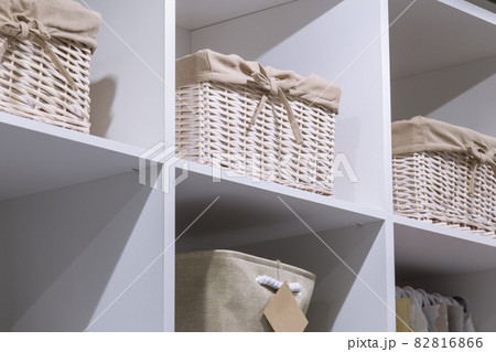 Organization of home space, order, cleanliness and comfort. Household goods storage equipment. Box baskets are woven fabric from trendy natural eco-friendly materials. Interior decor element 82816866