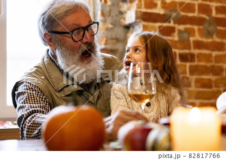 Little cute girl, kid visit grandparents and celebrate Thanksgiving day at home, indoors. Family, holiday concept. Little cute girl, kid visit grandparents and celebrate Thanksgiving day at home, indoors. Family, holiday concept. 82817766