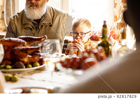 Little cute boy, kid visits grandparents and celebrate Thanksgiving day at home, indoors. Family, holiday concept. Little cute boy, kid visits grandparents and celebrate Thanksgiving day at home, indoors. Family, holiday concept. 82817829
