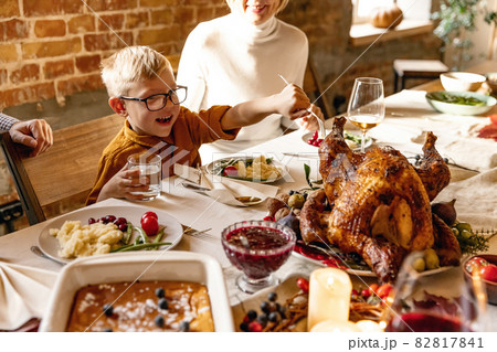 Little cute boy, kid visits grandparents and celebrate Thanksgiving day at home, indoors. Family, holiday concept. 82817841