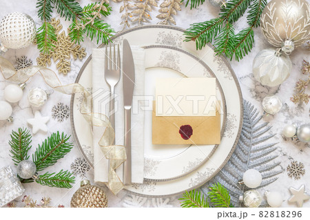 Festive table setting with Christmas decorations. Card and envelope mockup Festive table setting with Christmas decorations. Card and envelope mockup 82818296