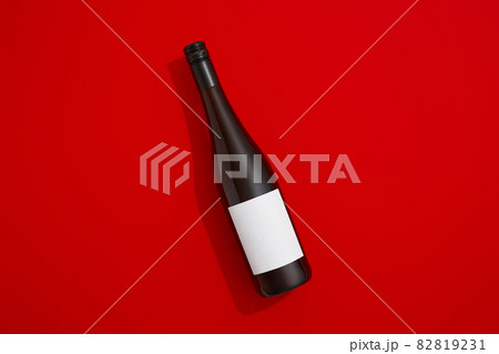 Wine bottle with blank label. Red wine on colorful background with copy space Wine bottle with blank label. Red wine on colorful background with copy space 82819231