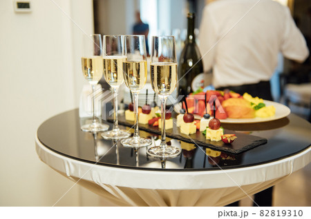 glasses with champagne and fruits on buffet table at a restaurant or in the hotel lobby 82819310